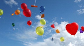 Helium-filled balloons in various colours